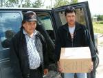 Charlie Moose and Jim Saggashie accept books donated by Stirling HallPoplar Hill Community Visit 04 08 11 013